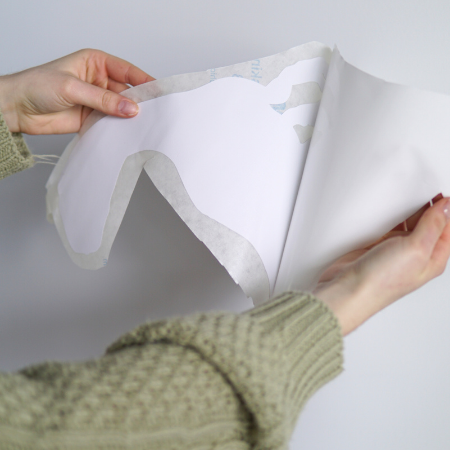 Peeling off the white backing film.